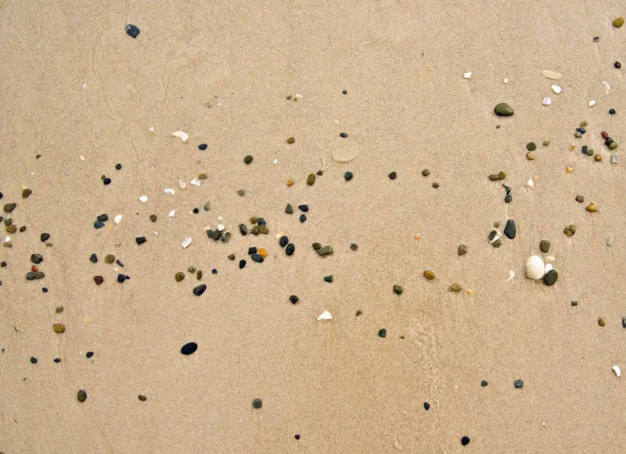 Small pebbles and stones in the beach sand
