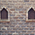 free castle windows in stone brick wall background photo