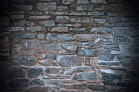 an old dirty and grungy stone wall background texture