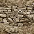 Sepia toned old stone brick wall background texture
