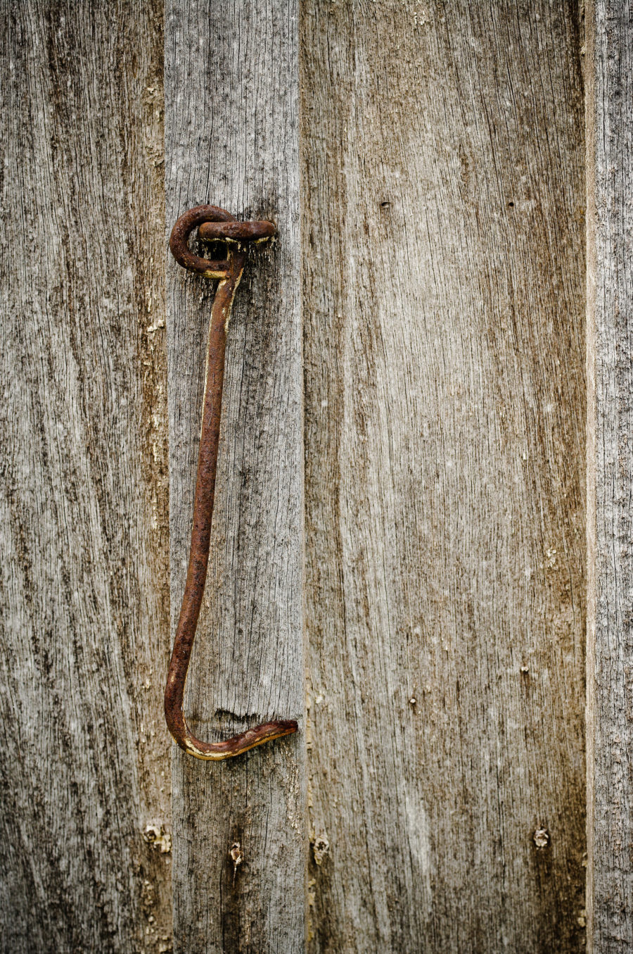 old grungy wood with a rusty hook photo