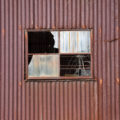 old rusty tin (corrugated iron) metal shed with window