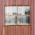 old rusty tin (corrugated iron) metal shed with window