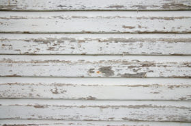 an old wood background with peeling paint