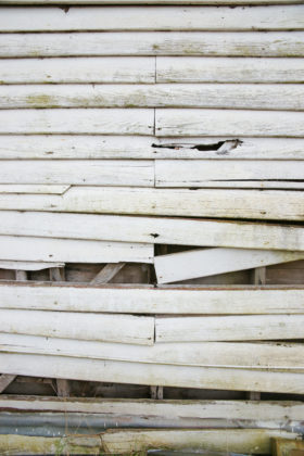 falling down old white weatherboard wooden wall background