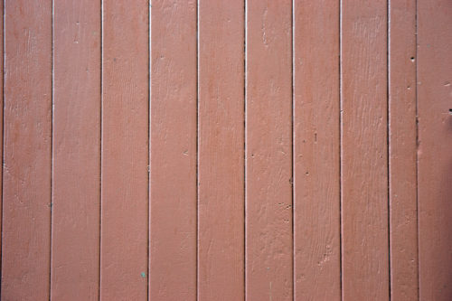 red-ish wooden panelled fence background