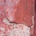 old worn grungy red concrete temple wall