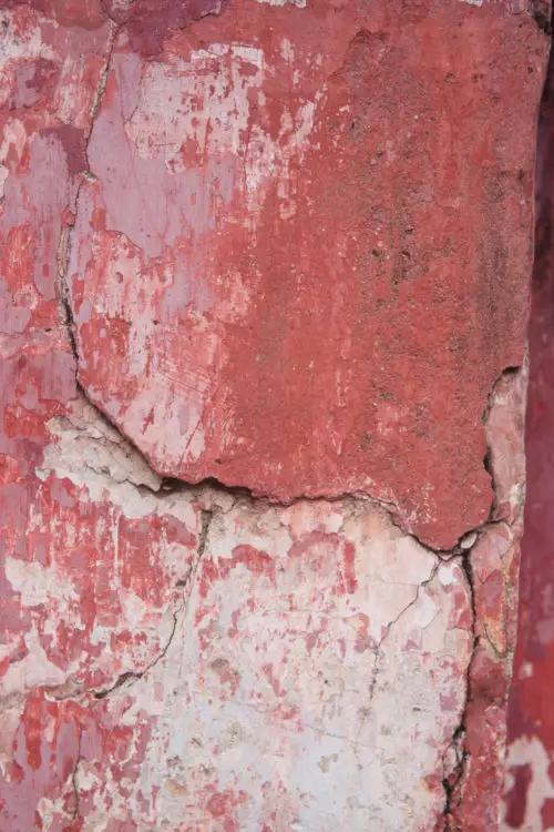 old worn grungy red concrete temple wall