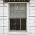 window in a white wooden wall