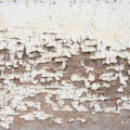 closeup of peeling paint on the weatherboard wood texture