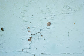 Two blue backgrounds of old cracked paint textures on metal