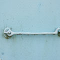 blue painted metal background with door catch