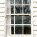 old window in wooden weatherboard wall