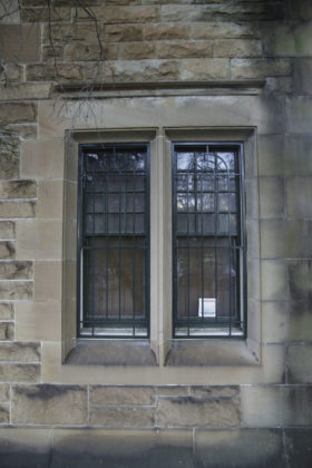 barred window in brick wall background texture