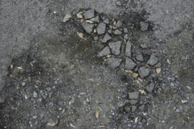 another rough stony bitumen road background texture