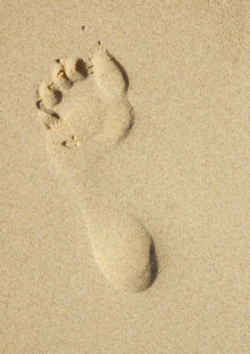 Two images of footprints in the sand