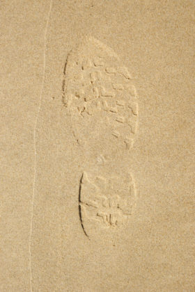 a shoe print in sand background texture