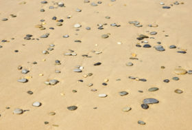 Pebble stones on the beach – two free background images