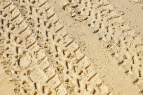 Two images of tyre / tire tracks in sand texture