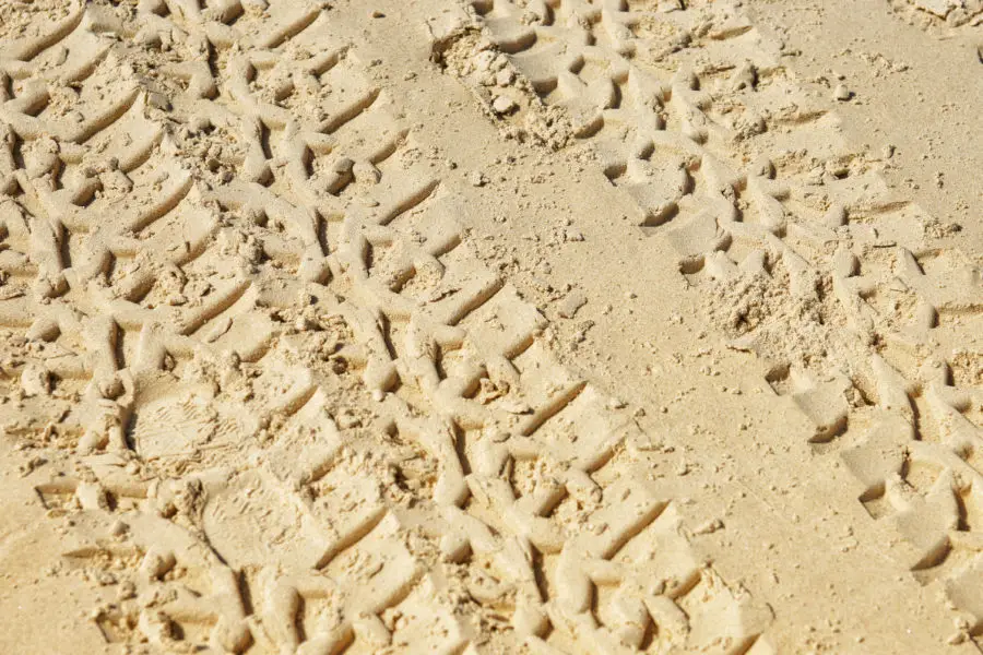 Two images of tyre / tire tracks in sand texture