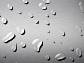 brushed metal background wihh water drops on it