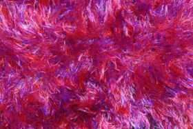 Really bright pink, red and purple fabric texture
