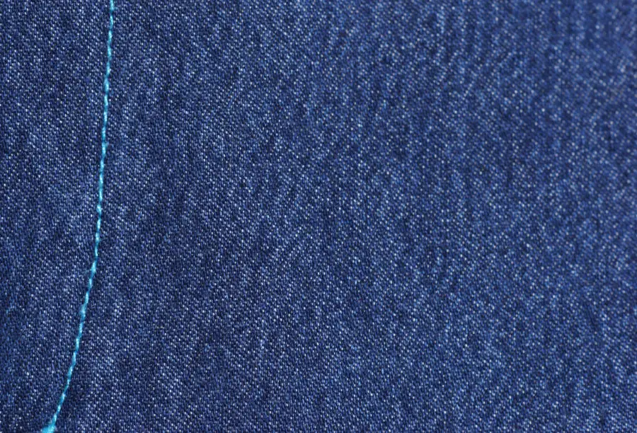 stitching on a blue denim jeans image