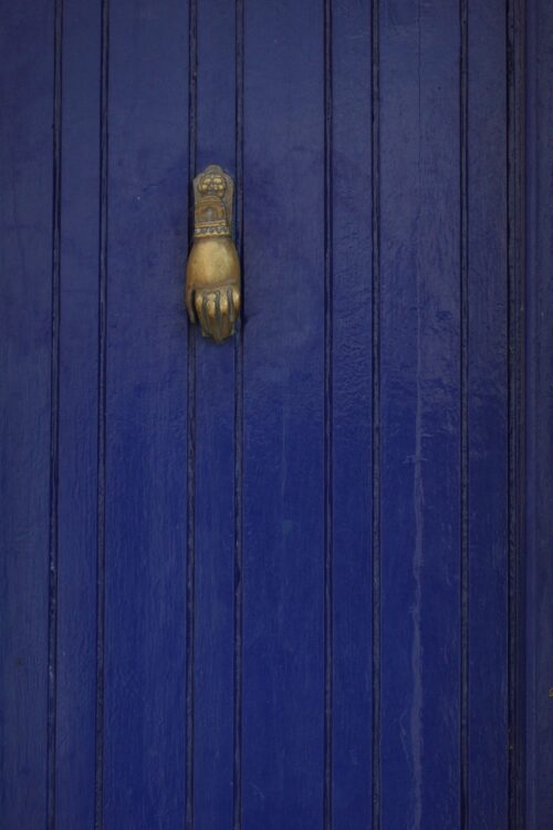 old blue door with bronze door knocker free stock photo